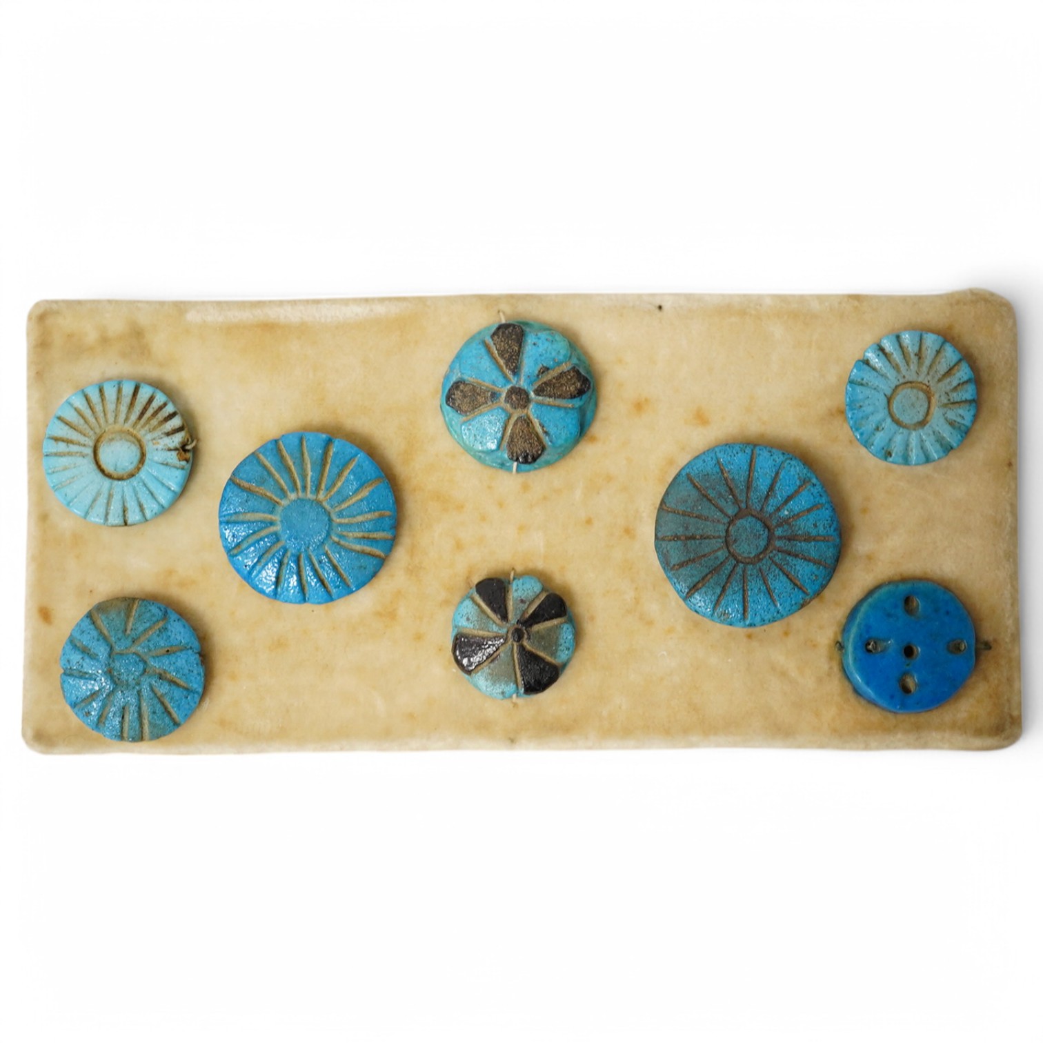 Antiquities - a group of eight blue glazed composition rosettes/buttons, used for garment decoration, 1000B.C - 600 B.C., largest 22mm. Condition - good for age and use